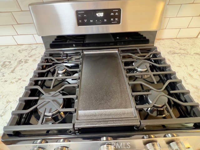 711 North Soldano Avenue, Unit 6 Azusa, CA 91702 - Photo 14 of 41 a close view of a stove top oven and cabinets
