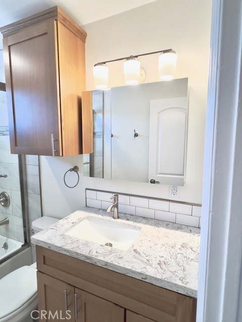 711 North Soldano Avenue, Unit 6 Azusa, CA 91702 - Photo 28 of 41 a bathroom with a granite countertop sink and a mirror
