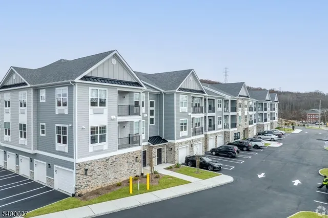 a front view of a house with swimming pool and sitting area