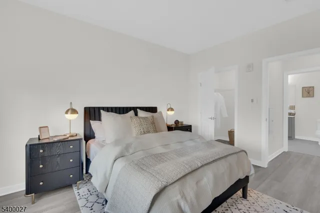 a bedroom with a bed and a night stand