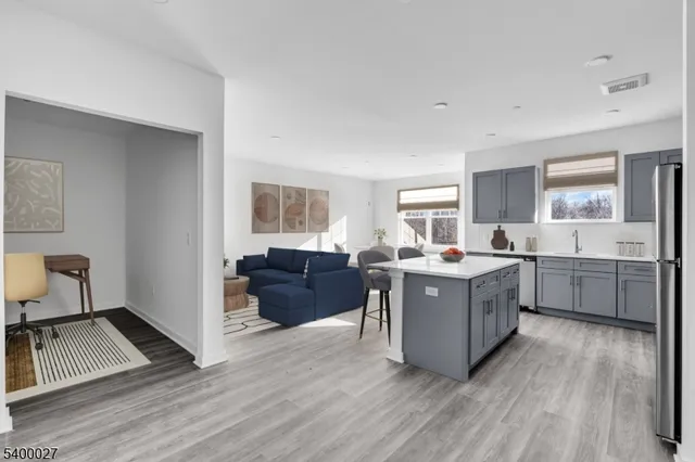 a living room with a couch and a stove top oven