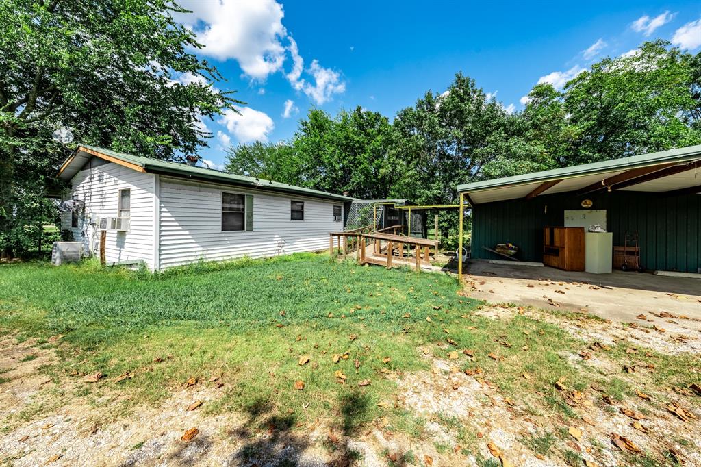 7801 West Interstate Highway Cumby, TX 75433 - Photo 32 of 32 a front view of house with yard and trees around