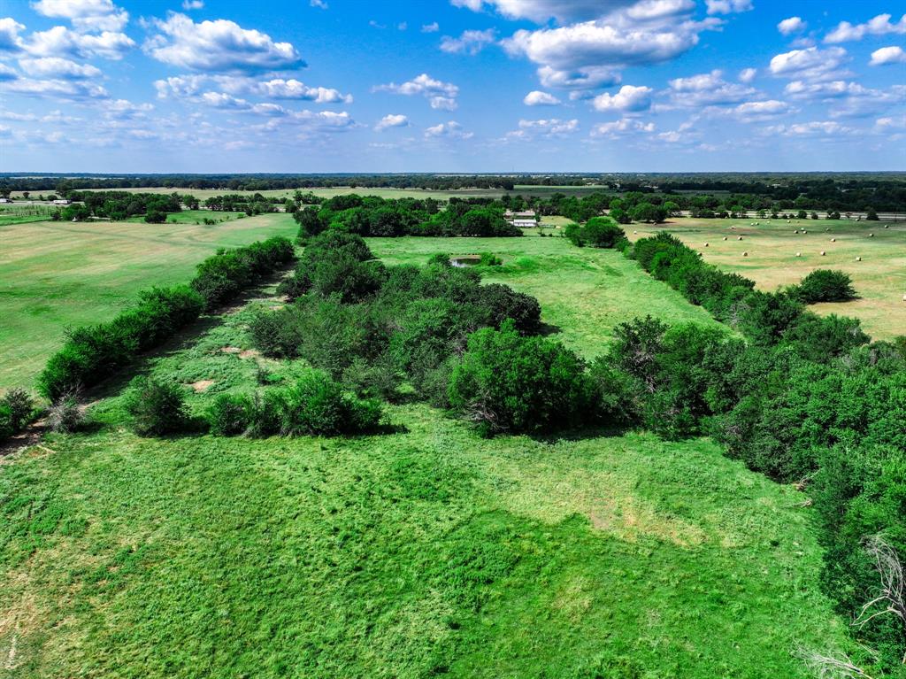7801 West Interstate Highway Cumby, TX 75433 - Photo 10 of 32 a view of a lush green outdoor space and a yard