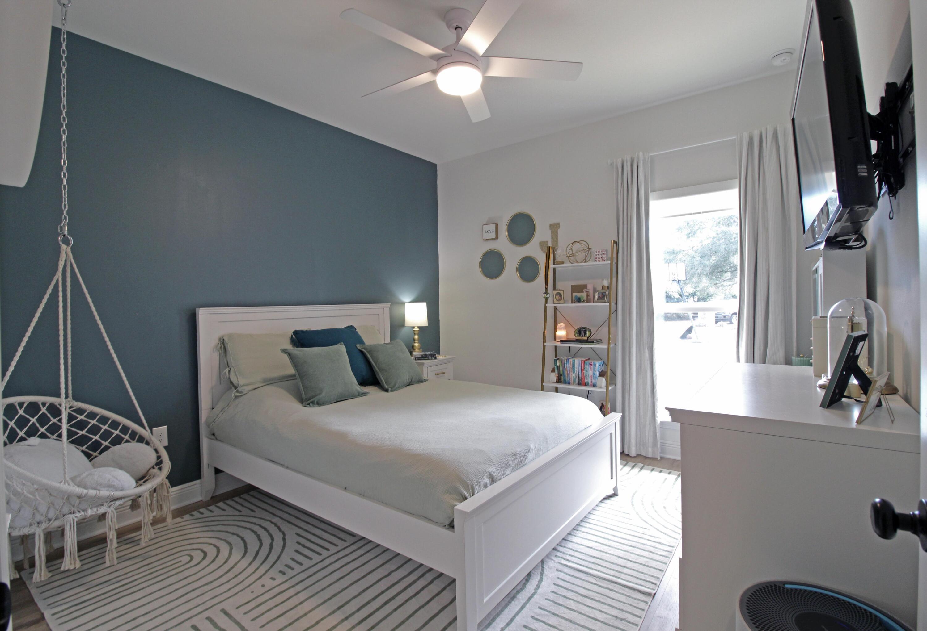 64 Indian Cove Freeport, FL 32439 - Photo 18 of 87 a bedroom with a bed and a flat tv screen on the dresser