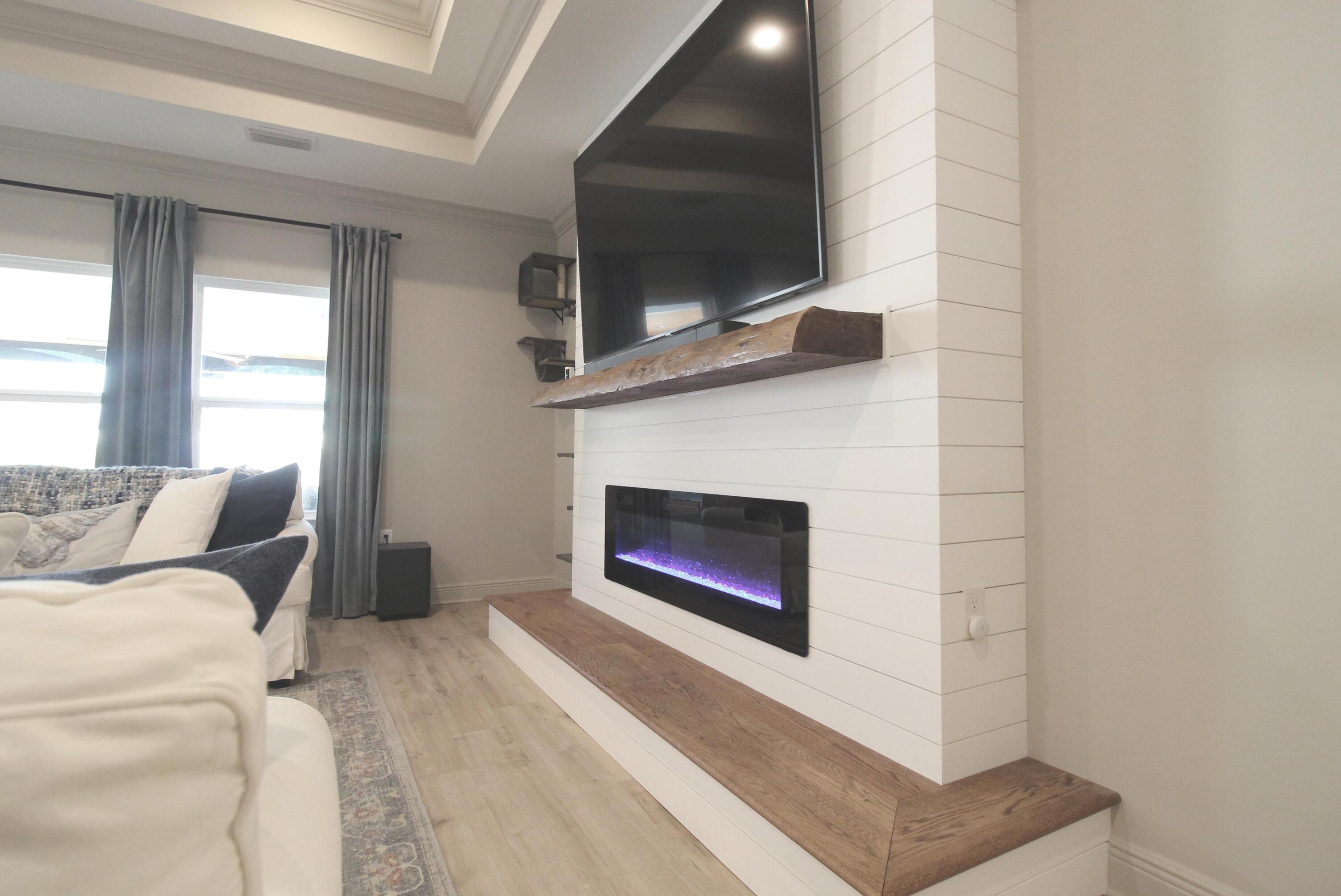 64 Indian Cove Freeport, FL 32439 - Photo 23 of 87 a living room with furniture a flat screen tv and a fireplace