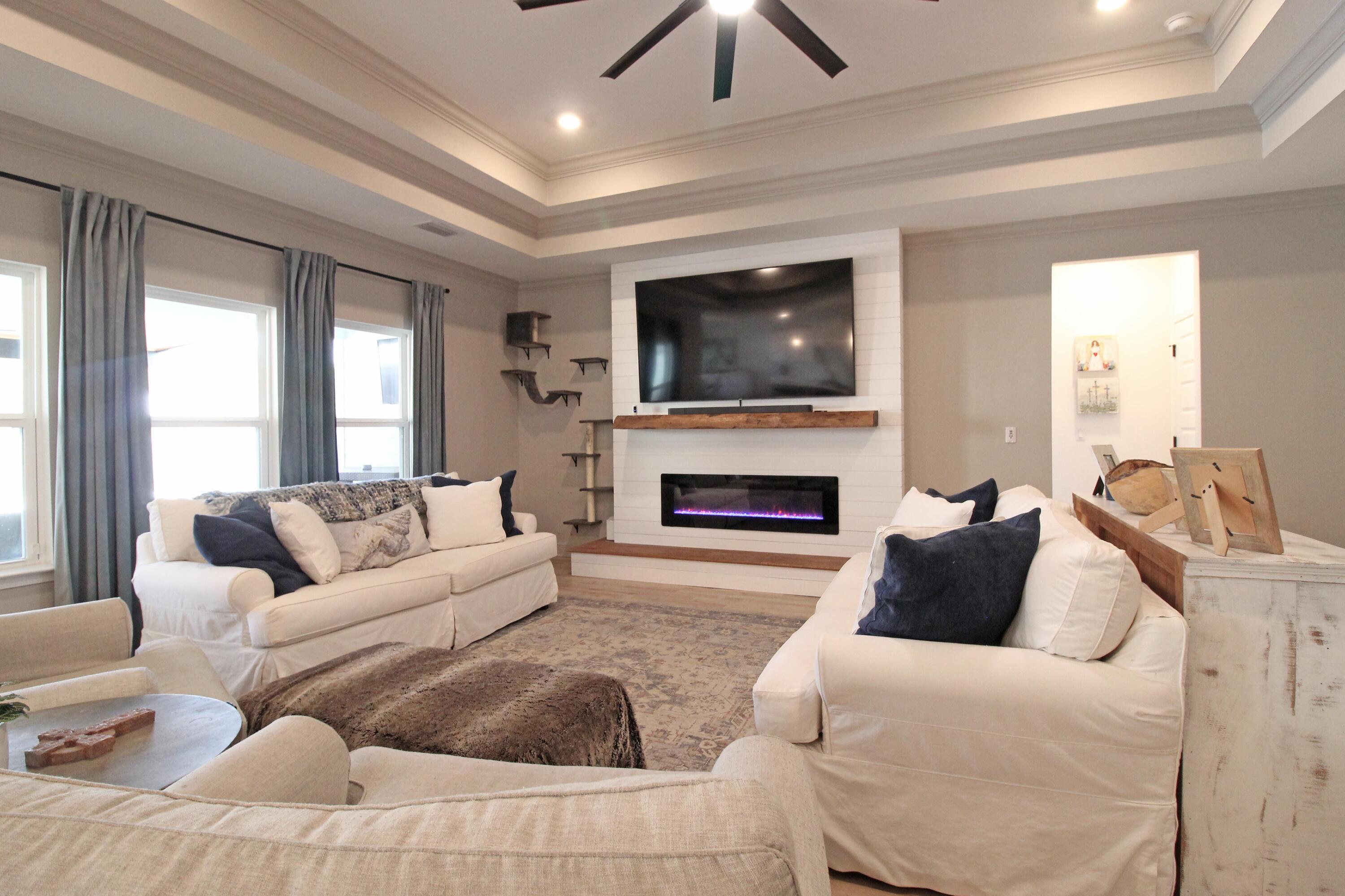 64 Indian Cove Freeport, FL 32439 - Photo 25 of 87 a living room with furniture a flat screen tv and a fireplace