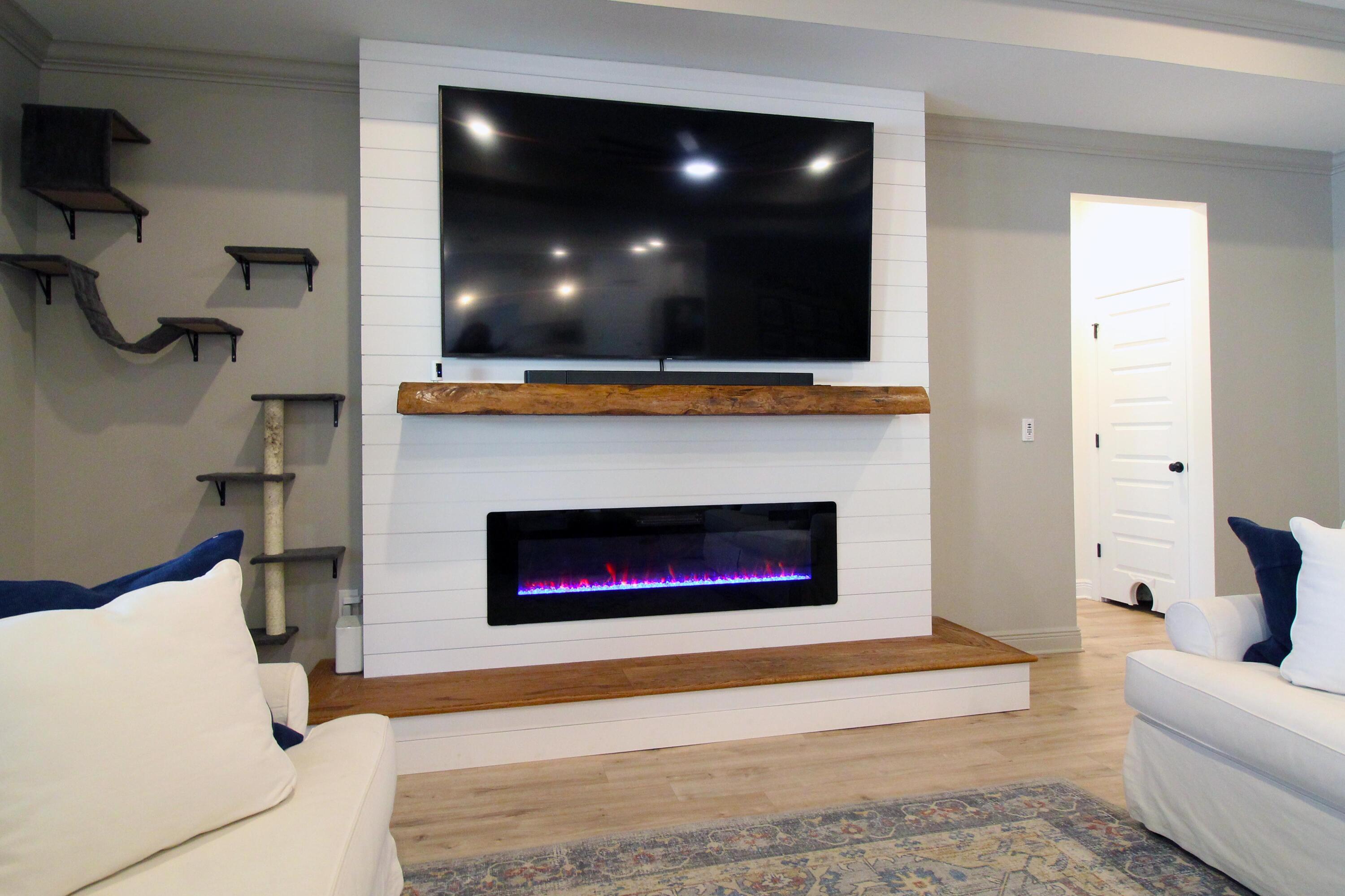 64 Indian Cove Freeport, FL 32439 - Photo 29 of 87 a living room with a fireplace and a flat screen tv