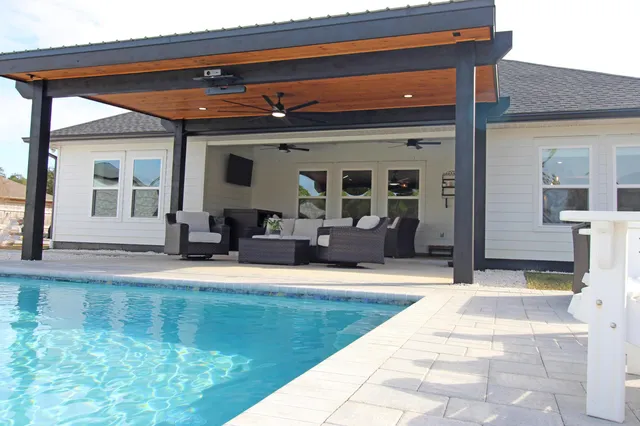 a living room with furniture a flat screen tv and a fireplace