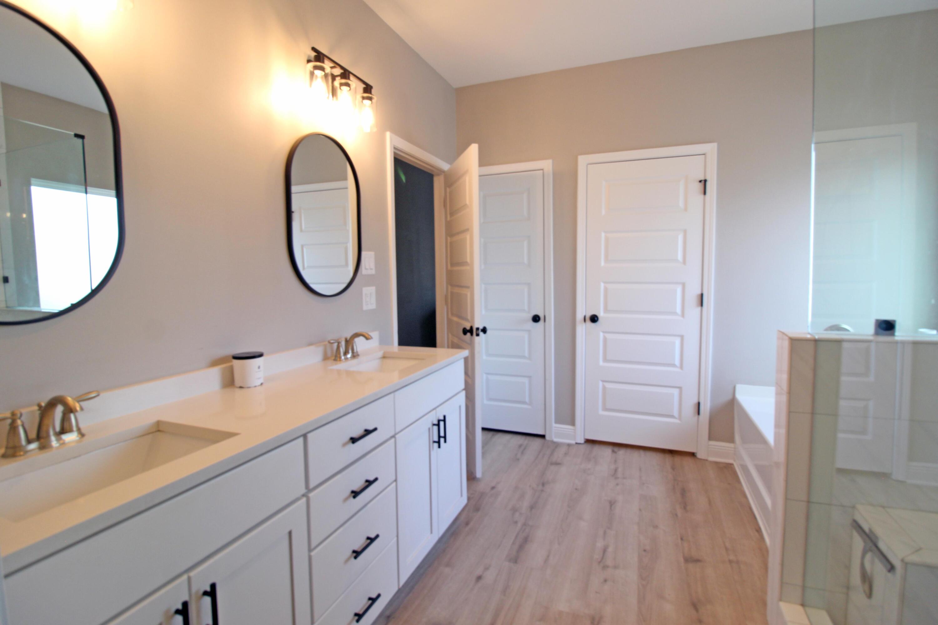 64 Indian Cove Freeport, FL 32439 - Photo 42 of 87 a spacious bathroom with a double vanity sink and a mirror