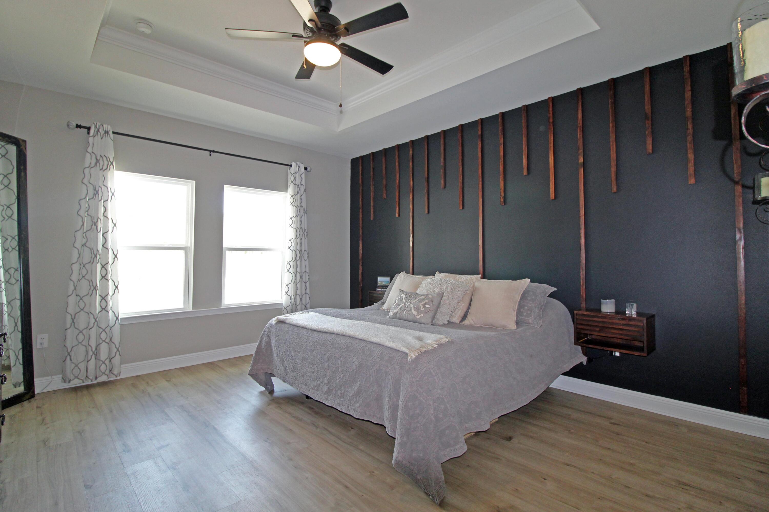 64 Indian Cove Freeport, FL 32439 - Photo 47 of 87 a bedroom with a bed window and a ceiling fan