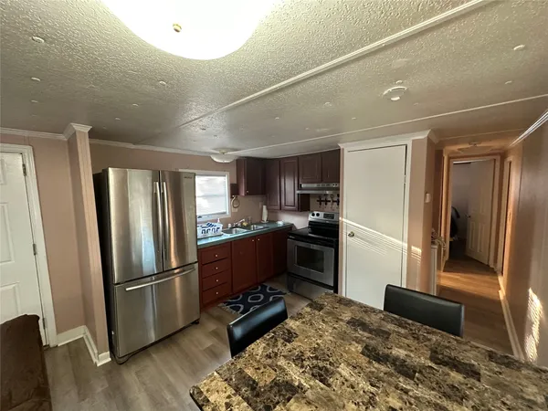 a kitchen with refrigerator a stove and a refrigerator
