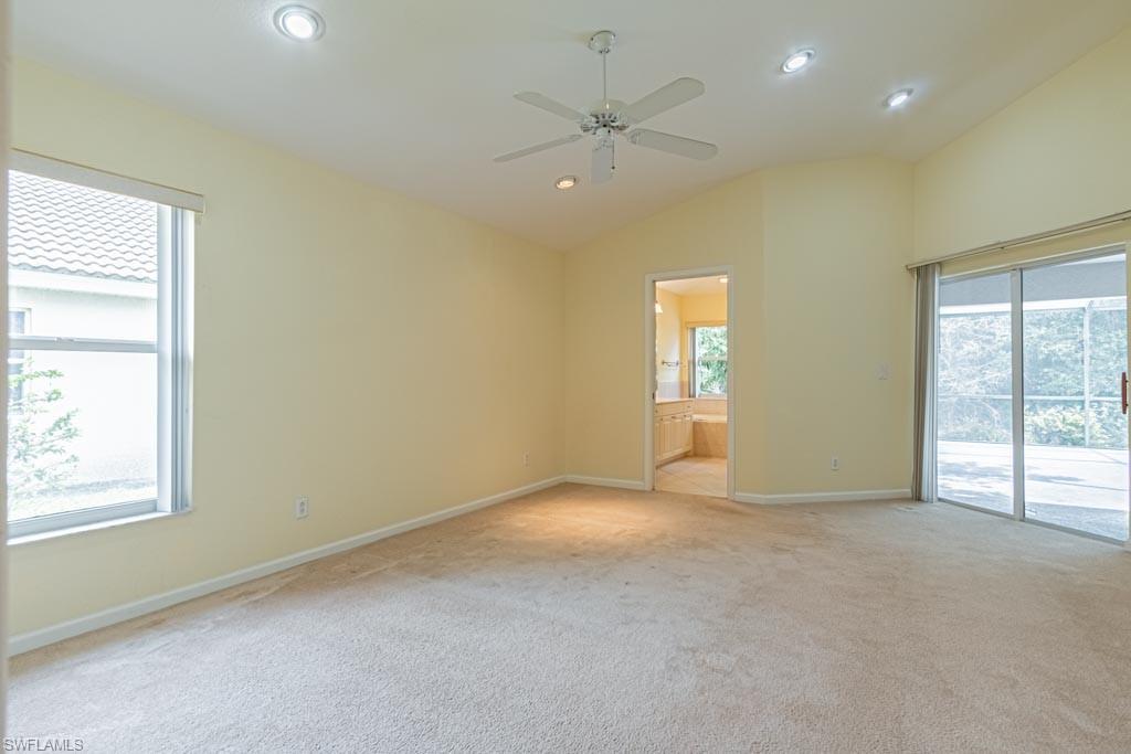 7101 Timberland Circle Naples, FL 34109 - Photo 21 of 50 an empty room with windows and ceiling fan