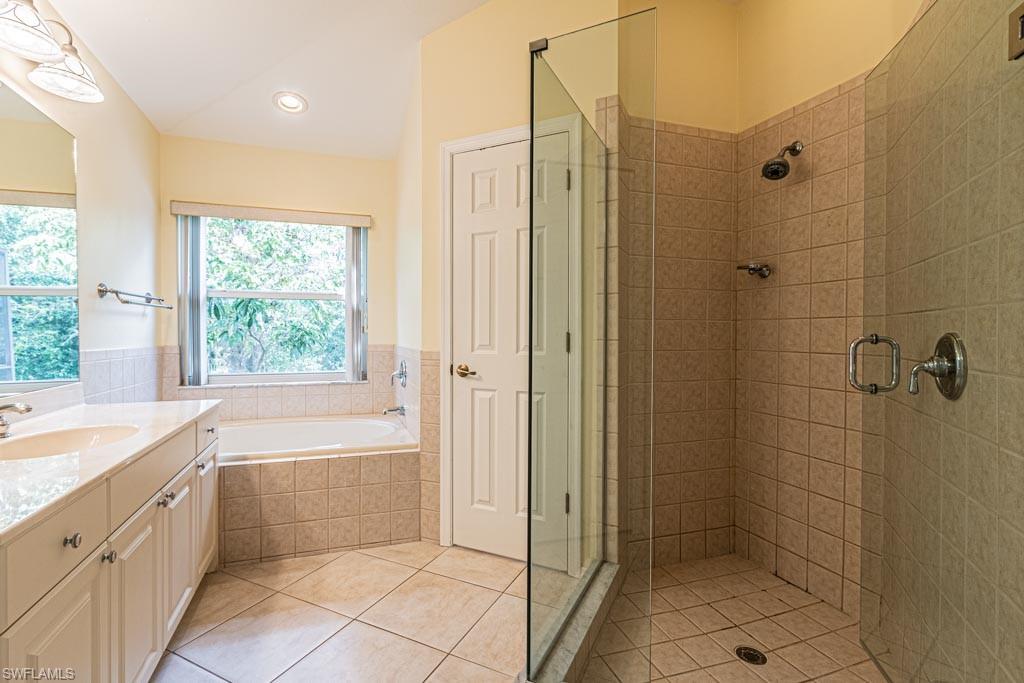 7101 Timberland Circle Naples, FL 34109 - Photo 23 of 50 a bathroom with a bathtub a sink and a shower