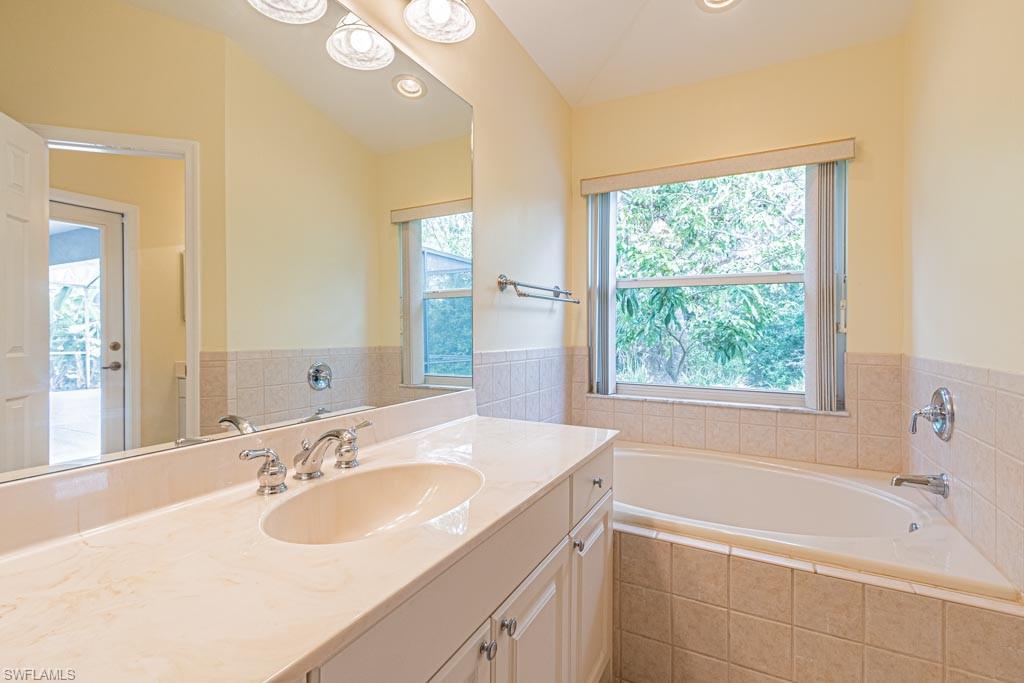 7101 Timberland Circle Naples, FL 34109 - Photo 27 of 50 a bathroom with a sink and a bathtub