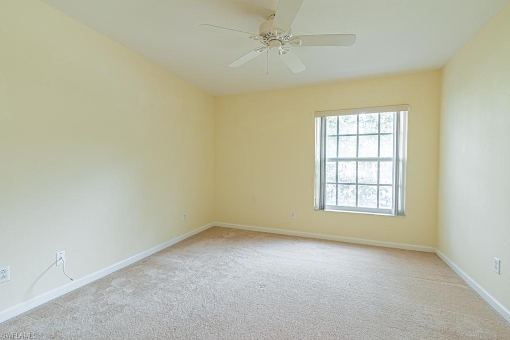 7101 Timberland Circle Naples, FL 34109 - Photo 30 of 50 an empty room with a window and a ceiling fan