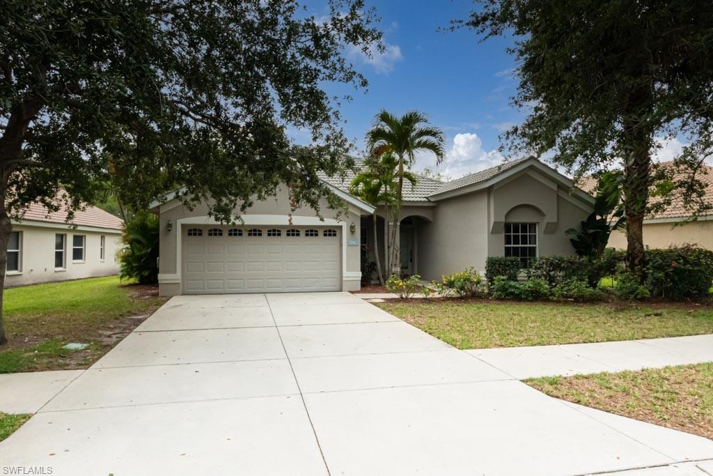 7101 Timberland Circle Naples, FL 34109 - Photo 3 of 50 a front view of a house with garden