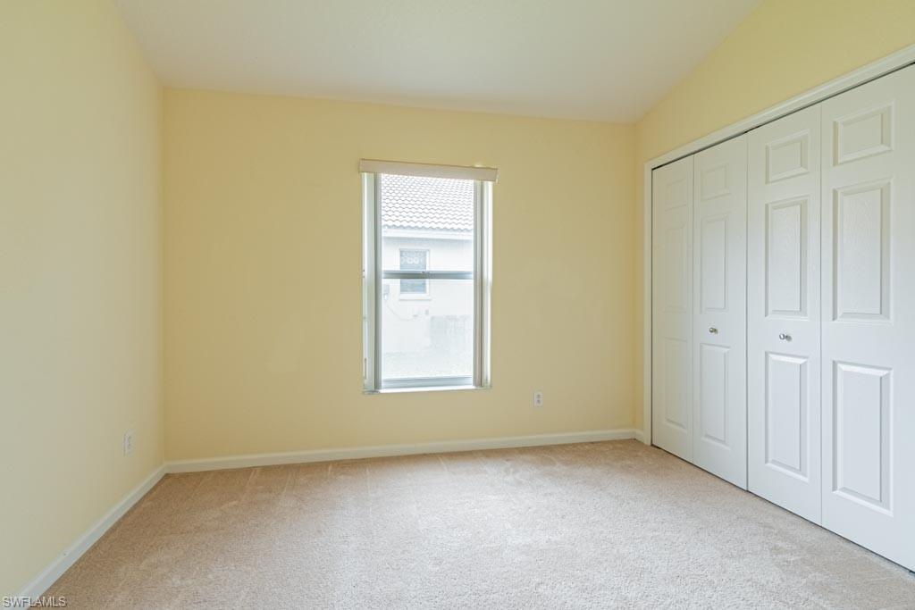 7101 Timberland Circle Naples, FL 34109 - Photo 33 of 50 an empty room with windows