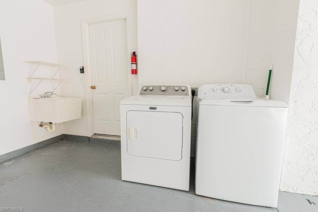 7101 Timberland Circle Naples, FL 34109 - Photo 37 of 50 a utility room with dryer and washer