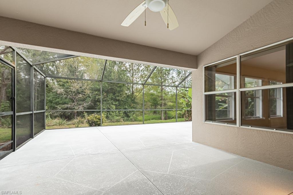 7101 Timberland Circle Naples, FL 34109 - Photo 40 of 50 a view of empty room with wooden floor and windows