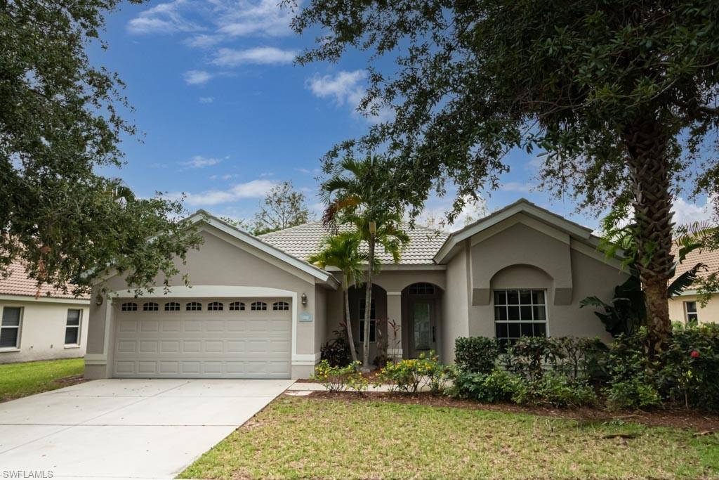 7101 Timberland Circle Naples, FL 34109 - Photo 4 of 50 a front view of a house with garden