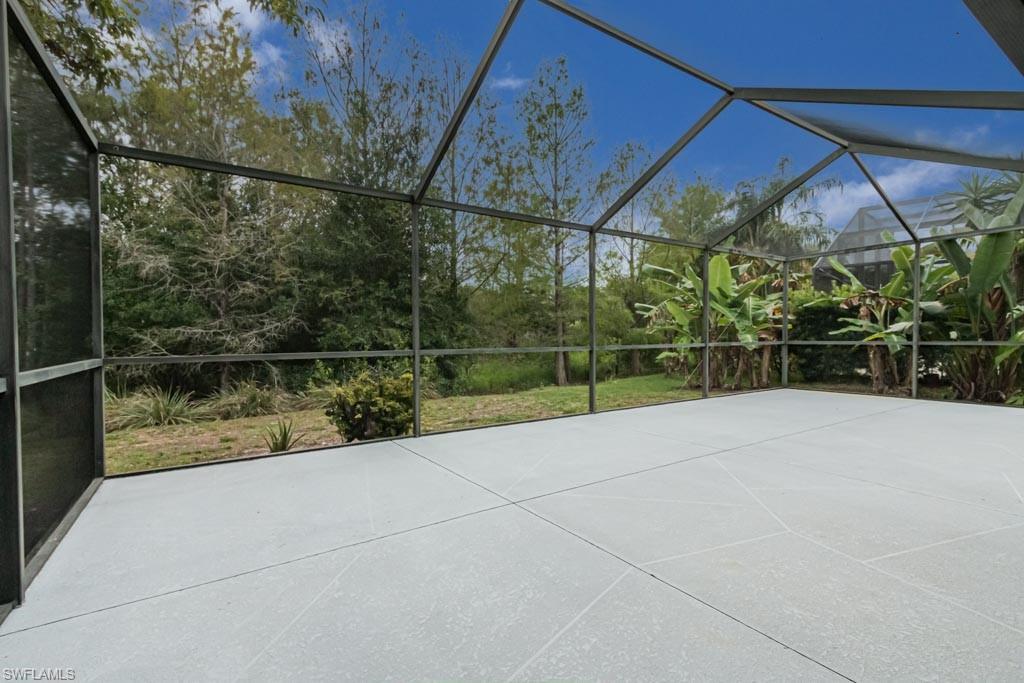 7101 Timberland Circle Naples, FL 34109 - Photo 42 of 50 a view of backyard with plants and a lake view