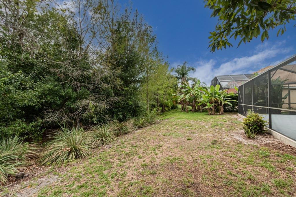 7101 Timberland Circle Naples, FL 34109 - Photo 48 of 50 a backyard of a house with lots of green space