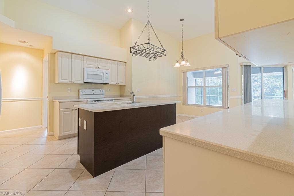 7101 Timberland Circle Naples, FL 34109 - Photo 7 of 50 a kitchen with a stove a sink and a refrigerator