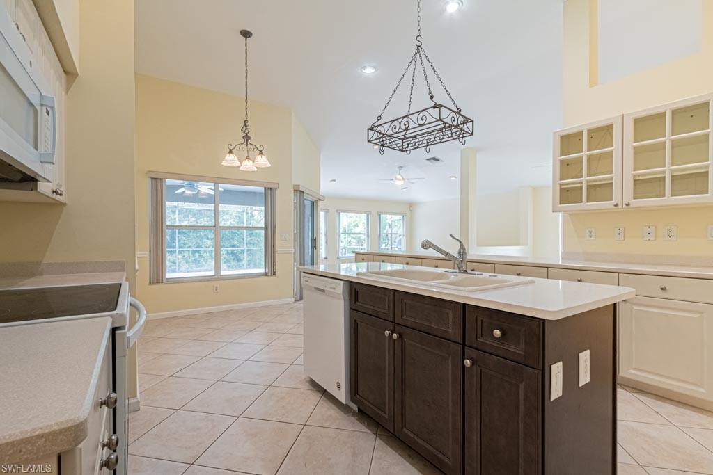 7101 Timberland Circle Naples, FL 34109 - Photo 9 of 50 a kitchen with a counter space appliances and cabinets