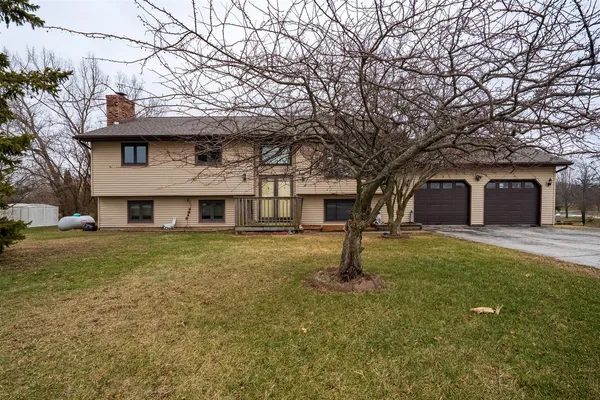 a view of a yard in front of a house with large tree