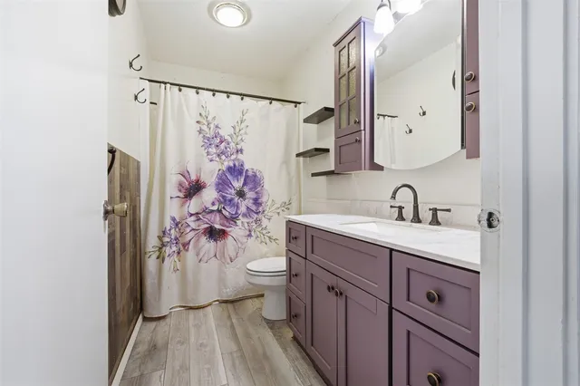 an empty room with chandelier fan