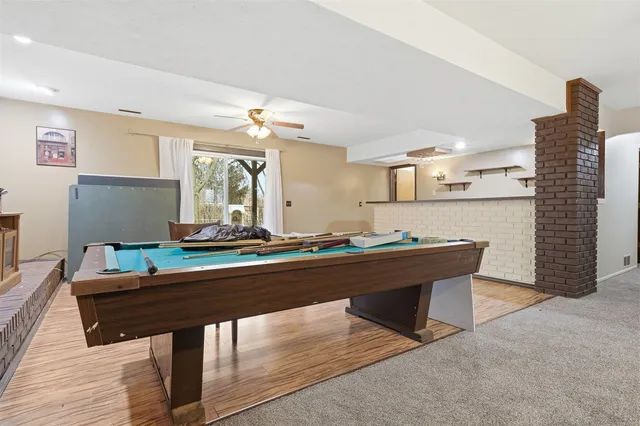 a view of kitchen with refrigerator and wooden floor