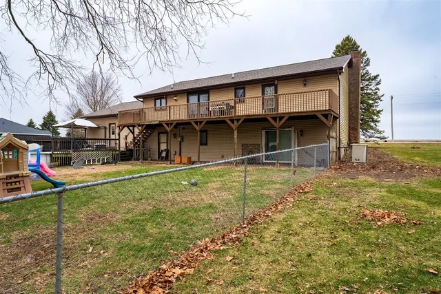 a balcony with wooden floor and trees in front of it