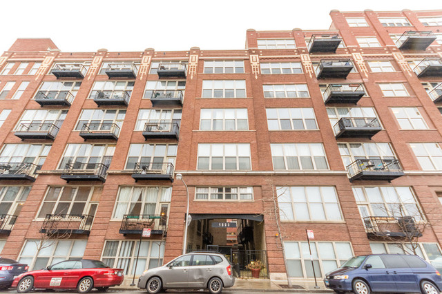 1500 West Monroe Street, Unit 715 Chicago, IL 60607 - Photo 1 of 26 a front view of a building with lot of cars parked