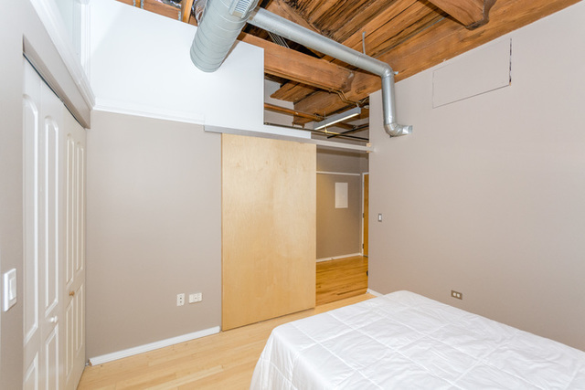 1500 West Monroe Street, Unit 715 Chicago, IL 60607 - Photo 11 of 26 a bedroom with a bed and a white wall