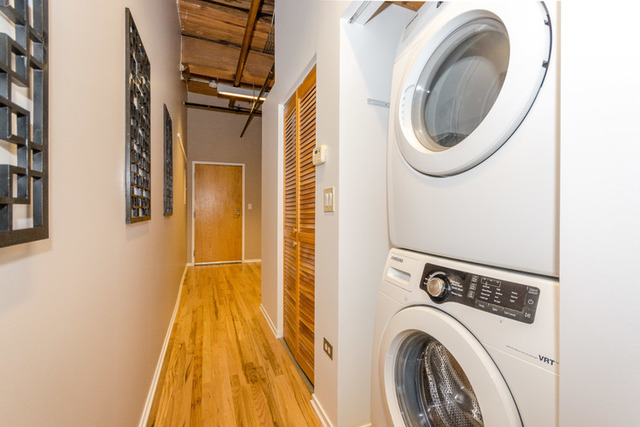 1500 West Monroe Street, Unit 715 Chicago, IL 60607 - Photo 16 of 26 a view of a bedroom with washer and dryer