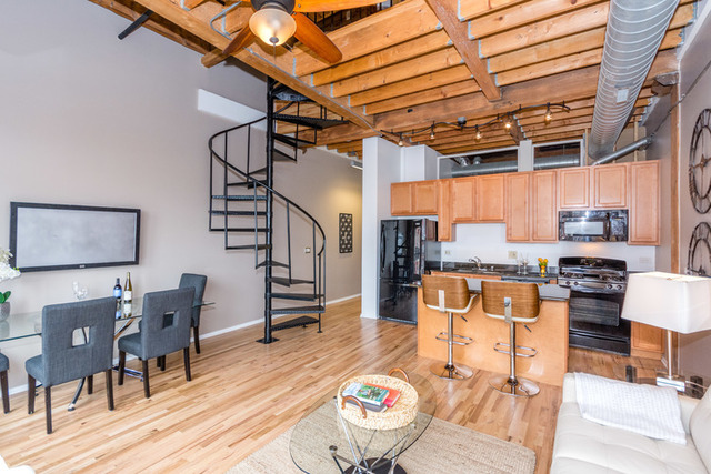 1500 West Monroe Street, Unit 715 Chicago, IL 60607 - Photo 6 of 26 a living room with lots of furniture and kitchen view