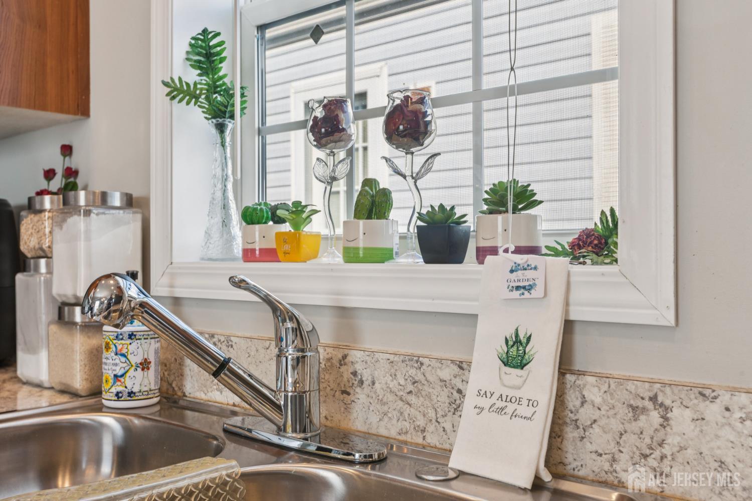 852 Highway 1, Unit X3 Edison, NJ 08817 - Photo 12 of 19 a kitchen with a sink and a potted plant