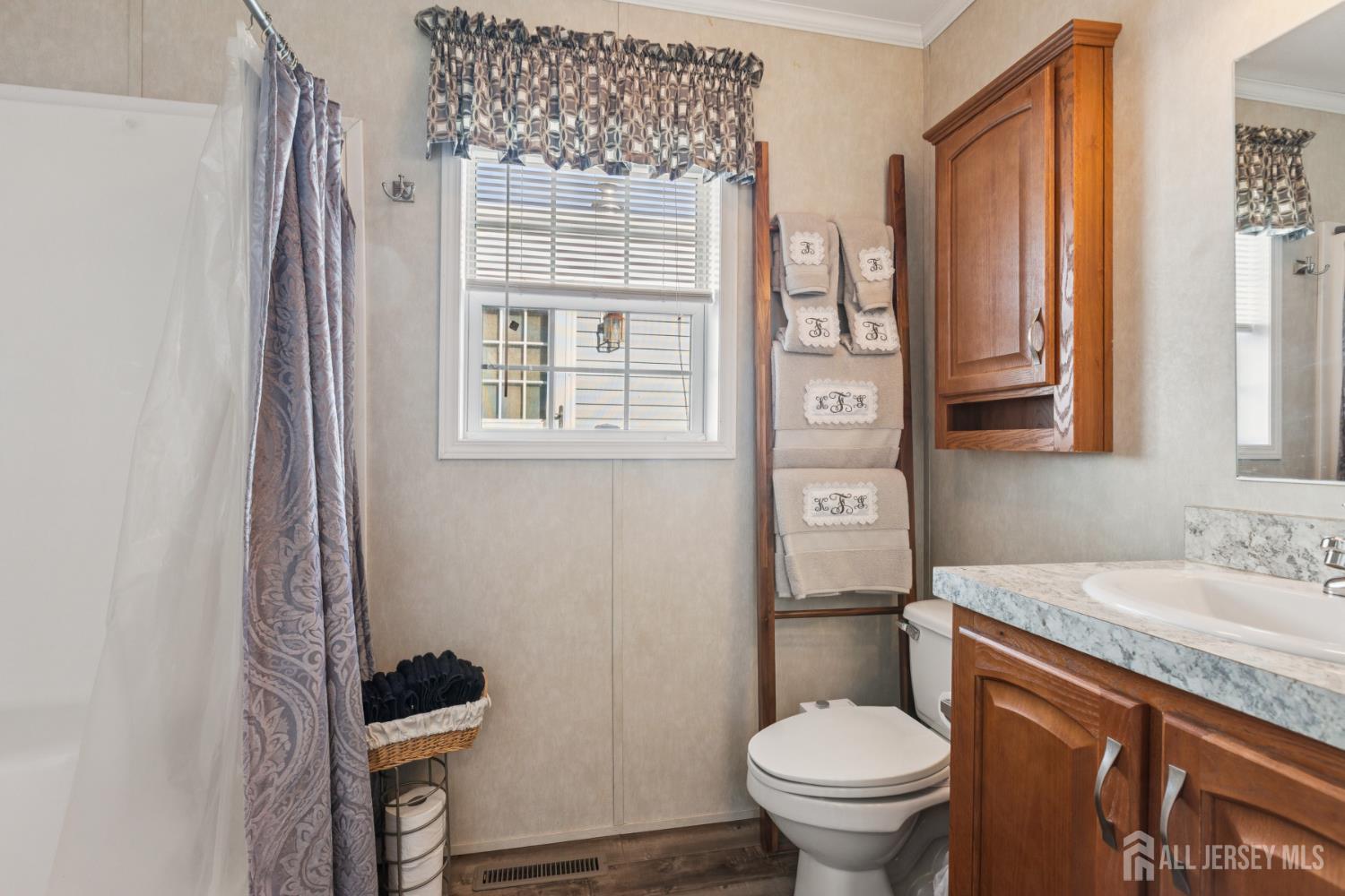 852 Highway 1, Unit X3 Edison, NJ 08817 - Photo 15 of 19 a bathroom with a granite countertop toilet sink and mirror