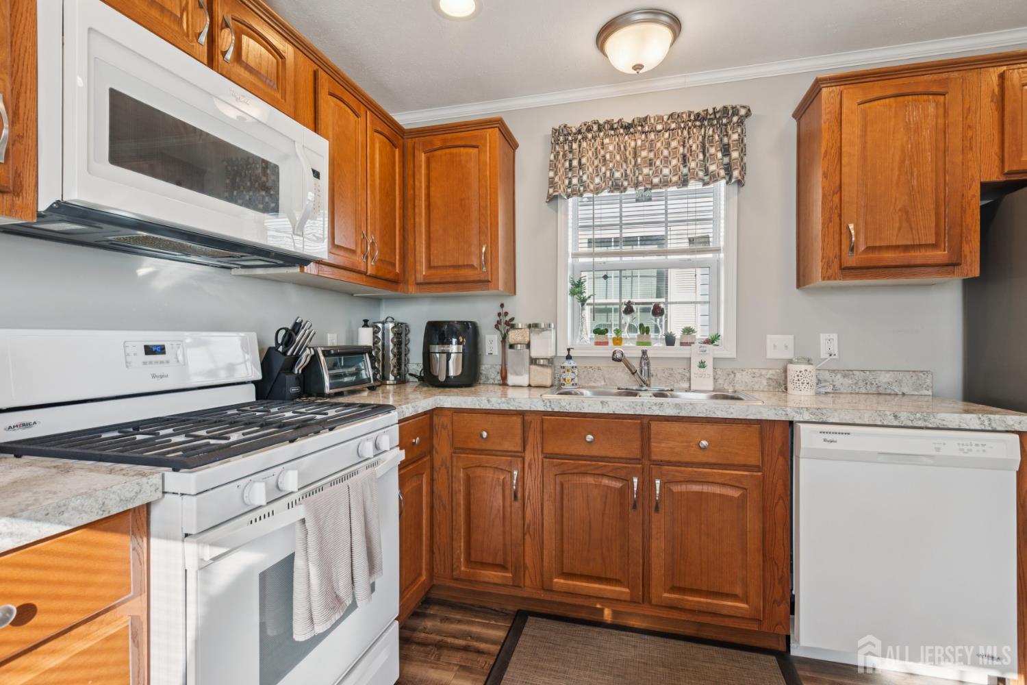 852 Highway 1, Unit X3 Edison, NJ 08817 - Photo 8 of 19 a kitchen with stainless steel appliances granite countertop a stove a sink and a microwave