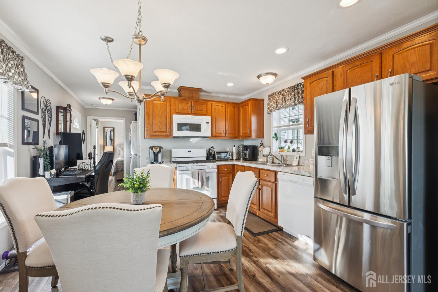 852 Highway 1, Unit X3 Edison, NJ 08817 - Photo 10 of 19 a kitchen with stainless steel appliances granite countertop a refrigerator a stove top oven a sink dishwasher a dining table and chairs with wooden floor