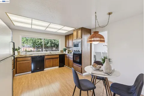 a kitchen with a table chairs stove and refrigerator