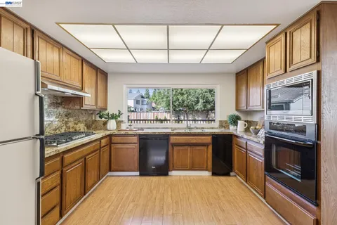 a kitchen with stainless steel appliances granite countertop a stove and a sink