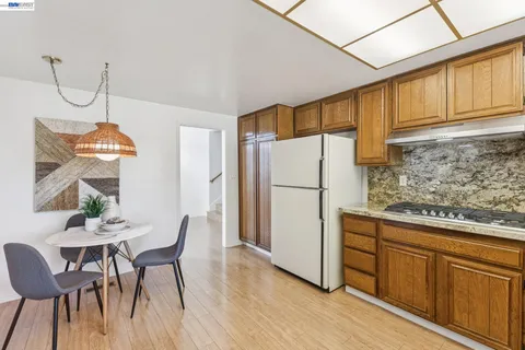 a kitchen with refrigerator cabinets dining table and chairs