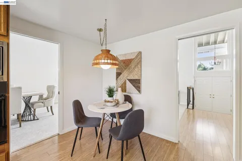 a view of a dining room with furniture wooden floor and a chandelier