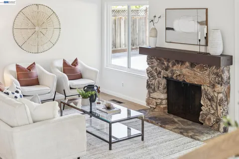 a living room with furniture a window and a fireplace