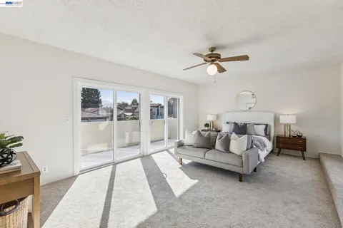 a living room with furniture and a ceiling fan