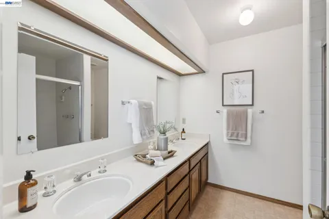 a bathroom with a double vanity sink and mirror