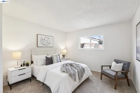 a bedroom with a bed and a lamp