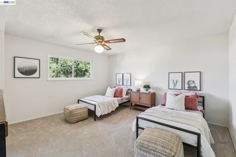 a bedroom with bed and a night stand