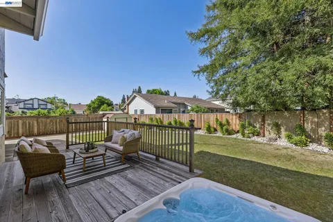 a view of a house with backyard and sitting area